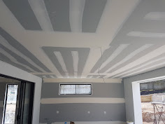 Joint finishing inspected with light travelling across the plasterboard surface