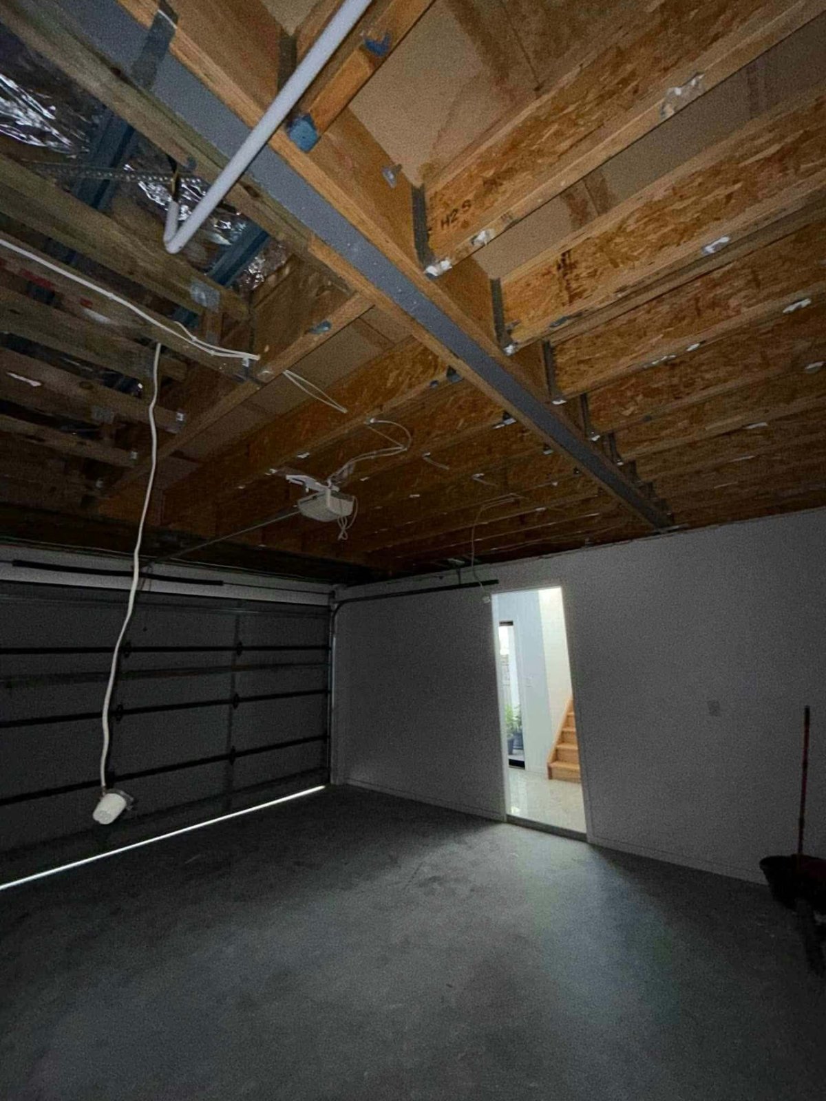Room prepared for ceiling replacement with protected fixtures and clear access