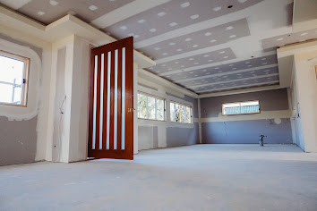 Unfinished wall framing with marked cabinet backing and electrical outlet positions