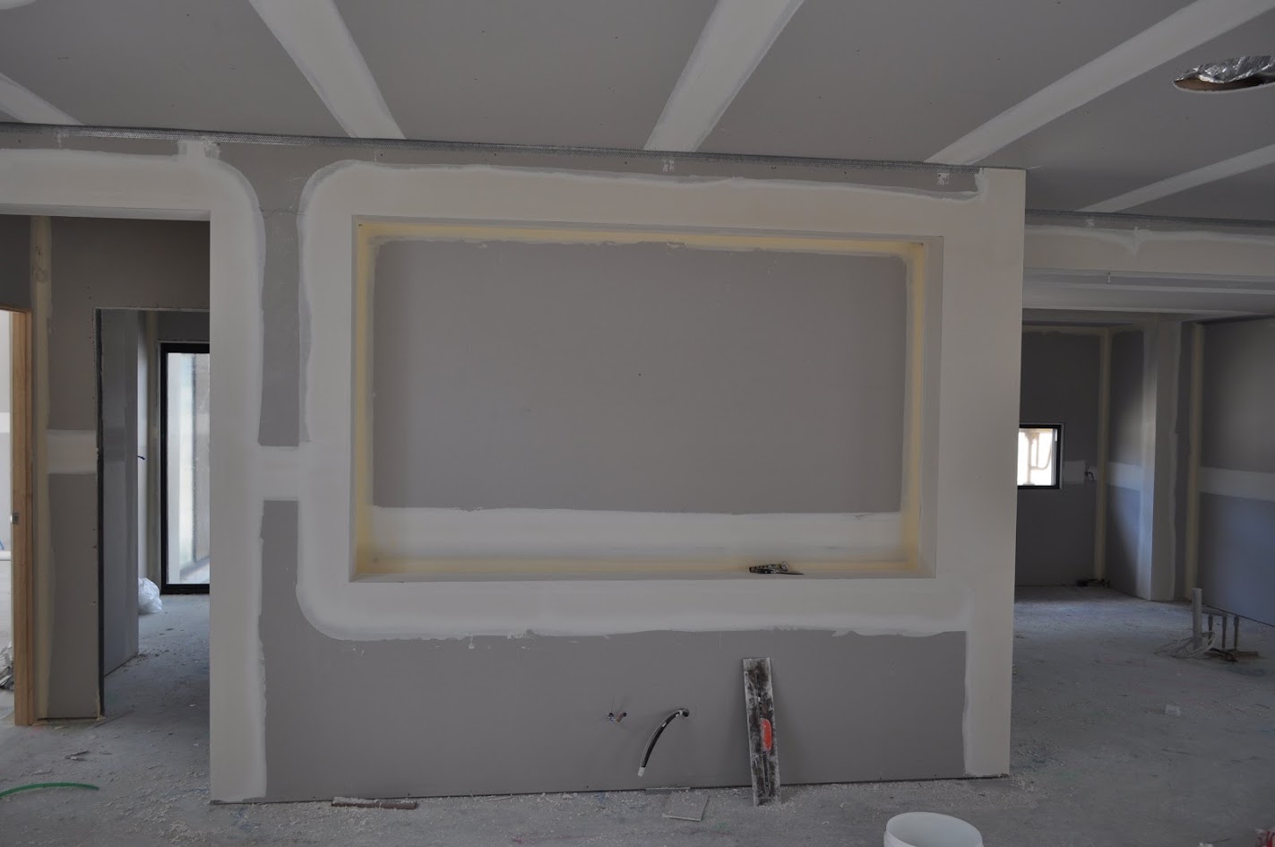Square-set wall and ceiling junction viewed beside a doorway