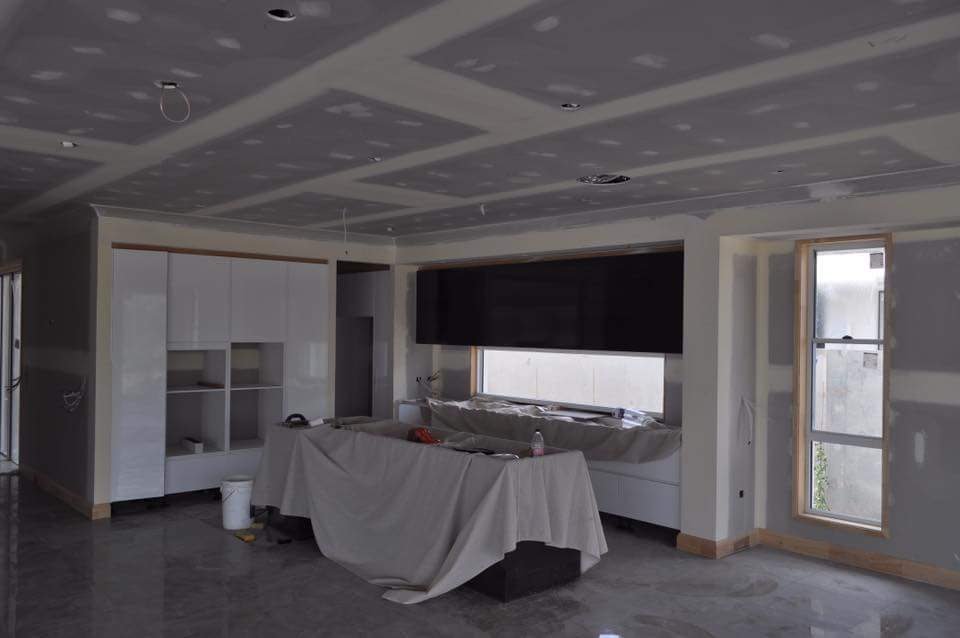 Plasterboard sheet layout around a doorway before joint finishing