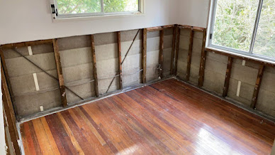Wall framing showing planned service openings before acoustic lining installation